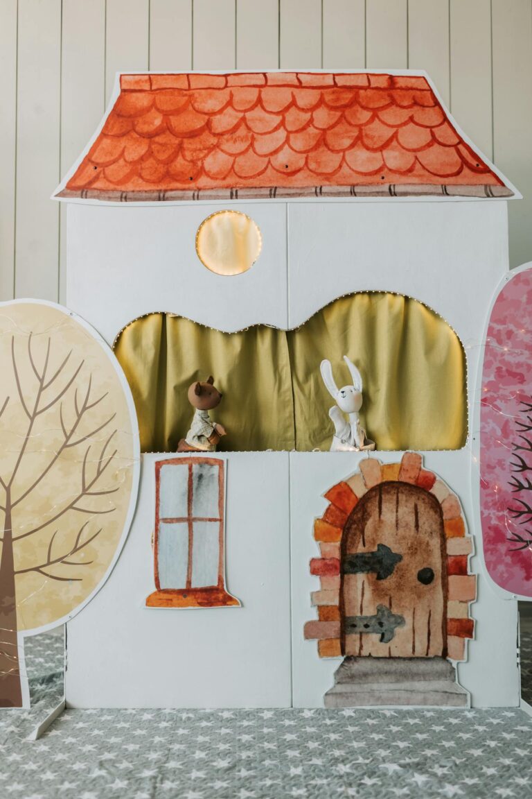 Colorful puppet theater for children's plays with stuffed animals.